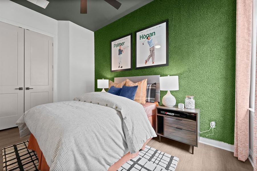 Bedroom featuring ceiling fan, a closet, and wood finished floors Bedroom featuring ceiling fan, a closet, and wood finished floors