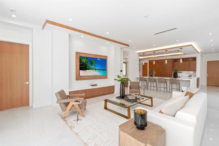 The family room offers breathtaking water views and a seamless connection to both the kitchen and dining room,