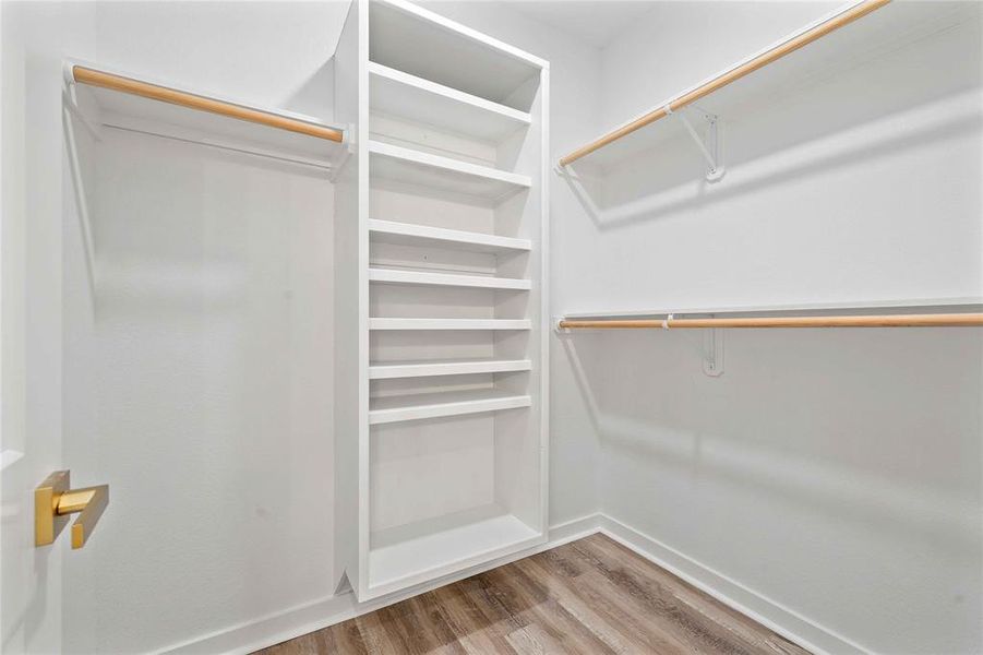 Spacious closet featuring light wood-type flooring Spacious closet featuring light wood-type flooring