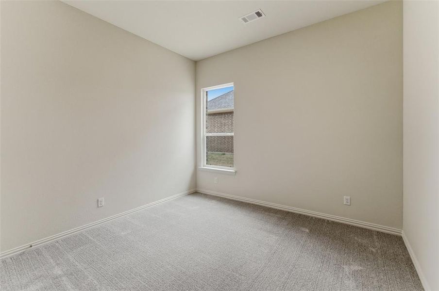 Unfurnished room featuring light carpet and baseboards
