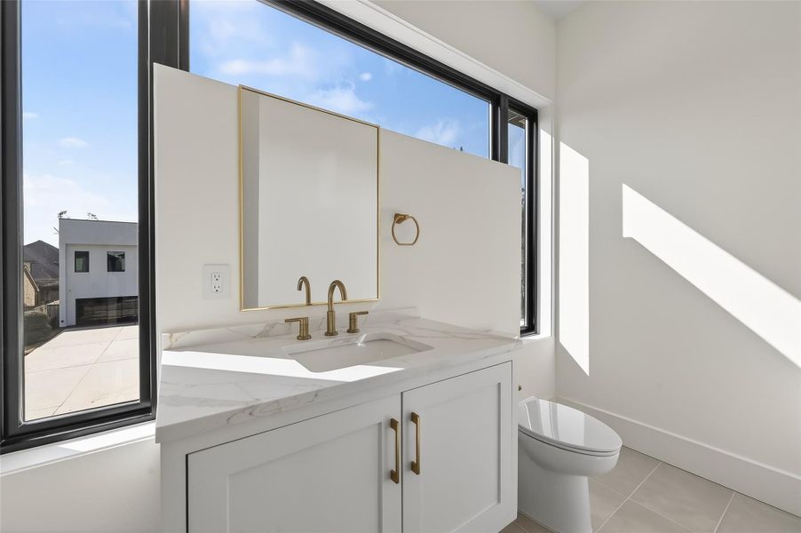 Beautiful powder bathroom conveniently integrated into the media room.