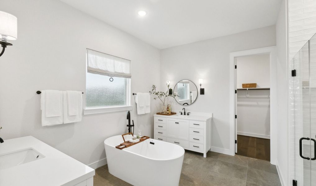 Primary bath with spacious vanities featuring matte black fixtures