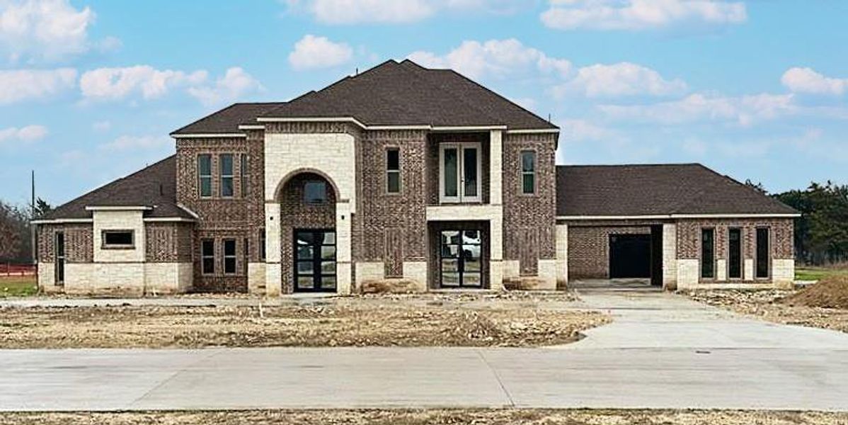 View of front facade with driveway and brick siding