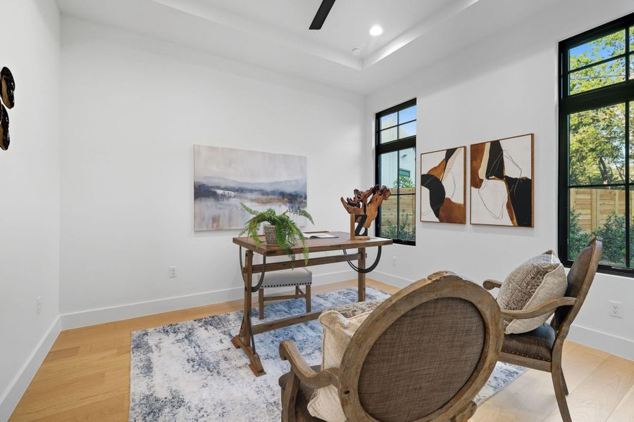 Home office with recessed lighting, light wood-style flooring, a raised ceiling, and a ceiling fan