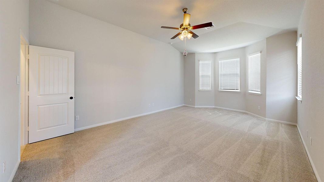Unfurnished room with light colored carpet and ceiling fan Unfurnished room with light colored carpet and ceiling fan