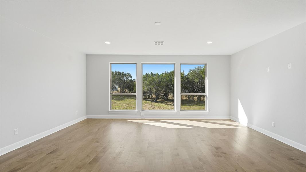 Empty room with light wood-type flooring and recessed lighting Empty room with light wood-type flooring and recessed lighting