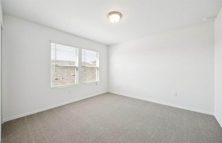 Spacious secondary bedroom with large windows Spacious secondary bedroom with large windows