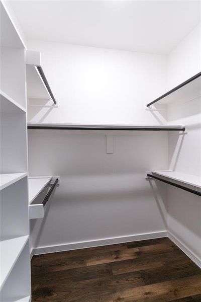 Walk in closet with dark wood-style floors Walk in closet with dark wood-style floors