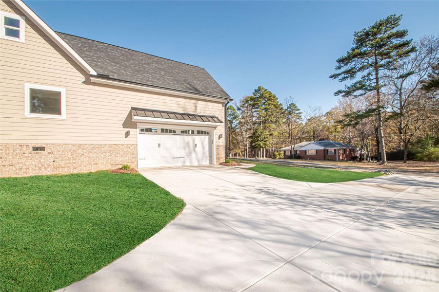 The garage offers exceptional depth and high ceilings, allowing for abundant storage options.
