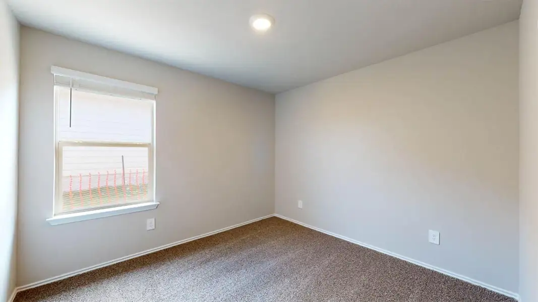 Carpeted spare room with baseboards