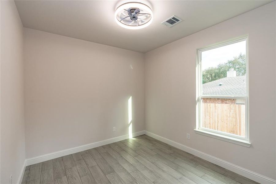 Bedroom with light hardwood / wood-style flooring