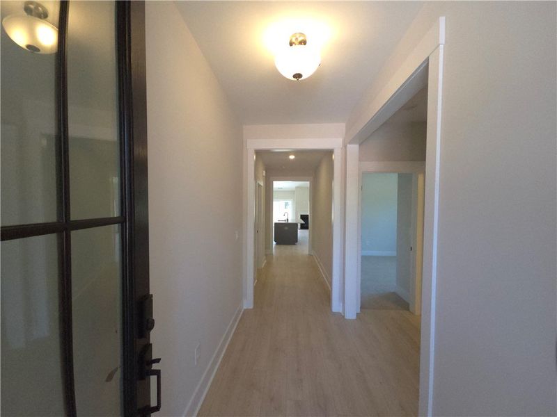 A spacious hallway features sleek flooring leading