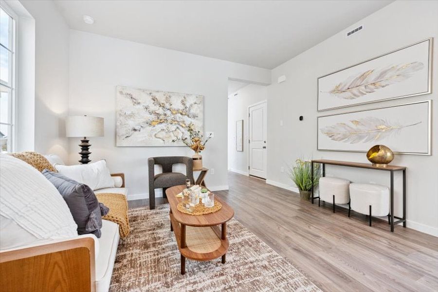 A living room with a wood floor. A living room with a wood floor.
