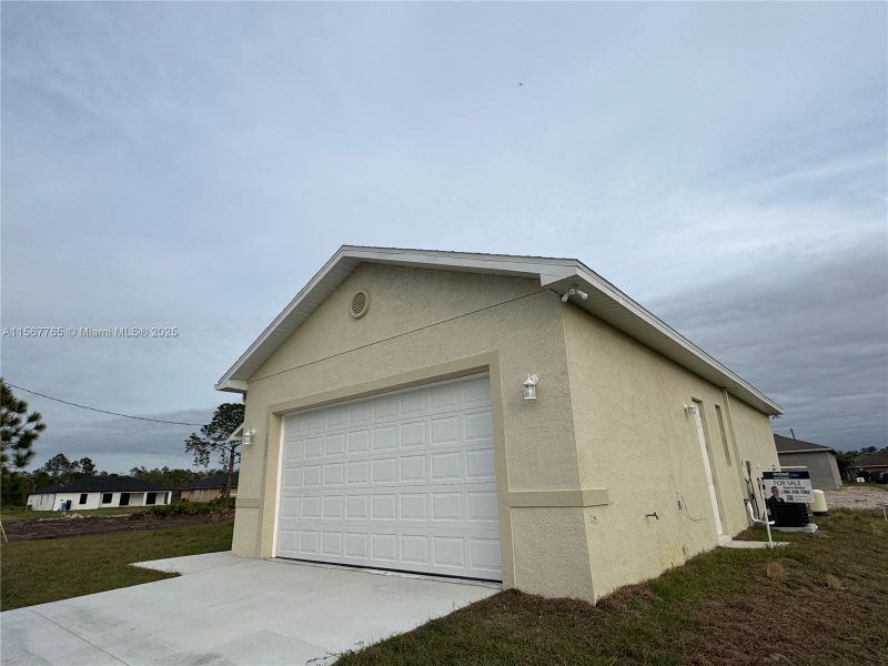 Front exterior of a new home in , Lehigh Acres, FL, highlighting curb appeal (Image 15).