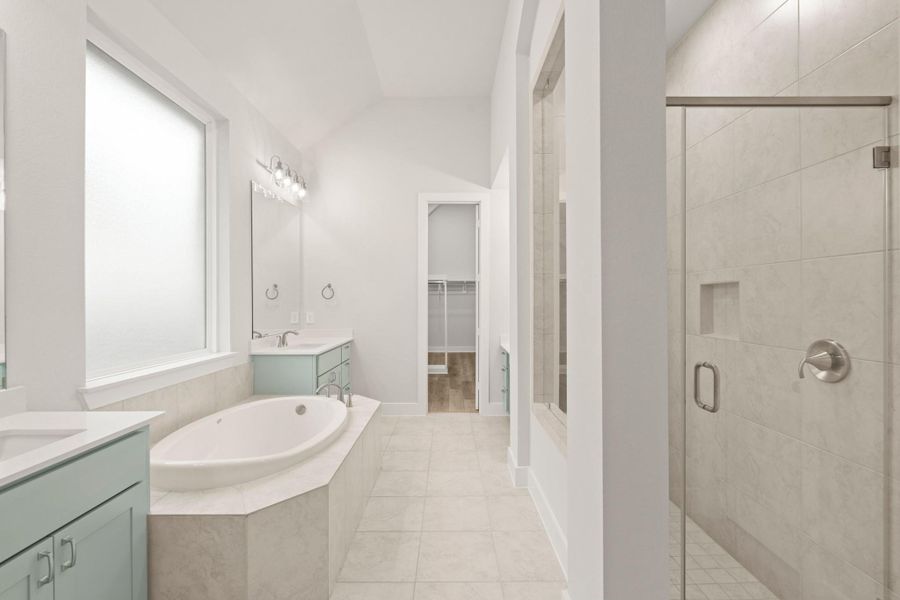 Primary ensuite with separate tub and shower, his/her cabinets/sinks