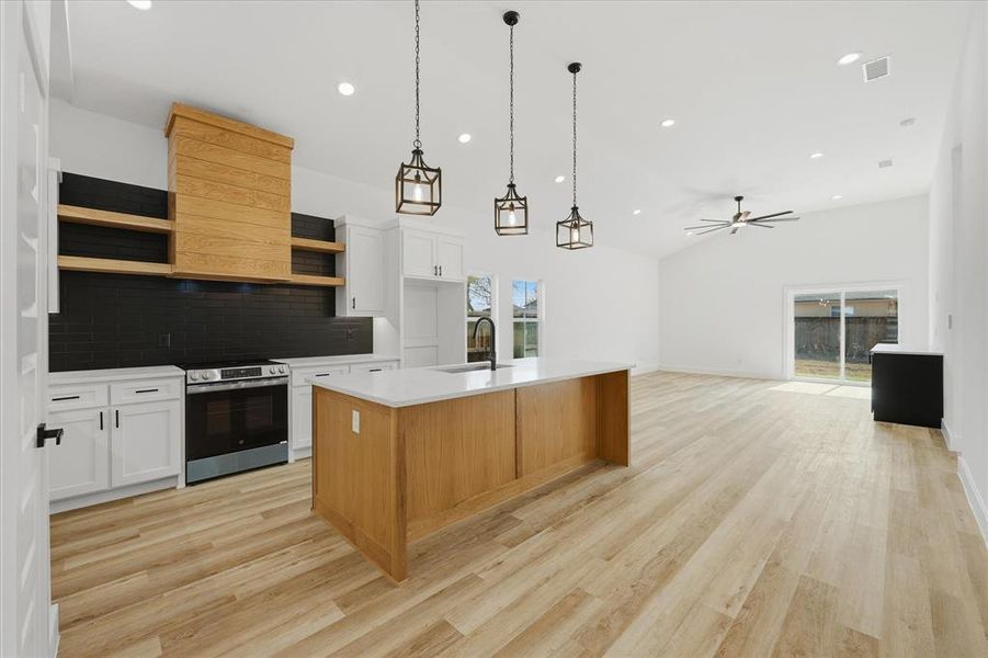 Kitchen featuring white cabinets, open shelves, decorative light fixtures, electric range, and a ceiling fan