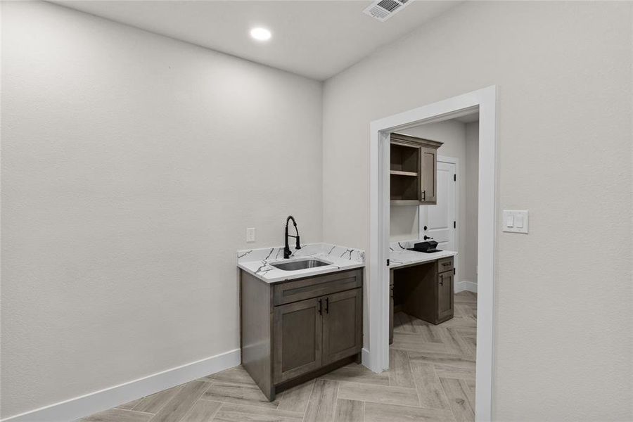 Bathroom with vanity and parquet flooring