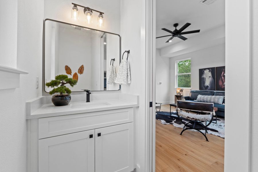 Clean lines and a modern vanity frame this elegant powder room adjacent to the living area.