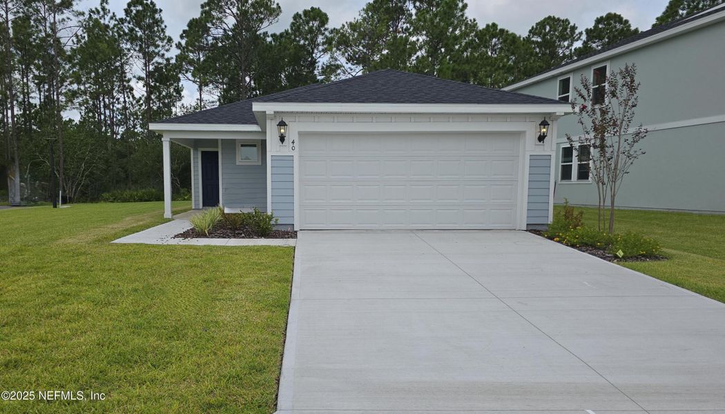 Front exterior of a new home in Flagler Village - Classic Series, Palm Coast, FL, highlighting curb appeal (Image 25). Front exterior of a new home in Flagler Village - Classic Series, Palm Coast, FL, highlighting curb appeal (Image 25).