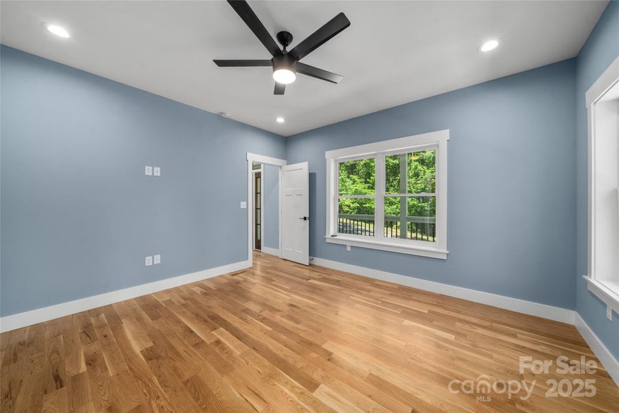 Primary bedroom tucked away in corner of main level