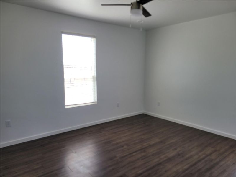Wood flooring and clean walls highlight this naturally illuminated space, ready for personalization.