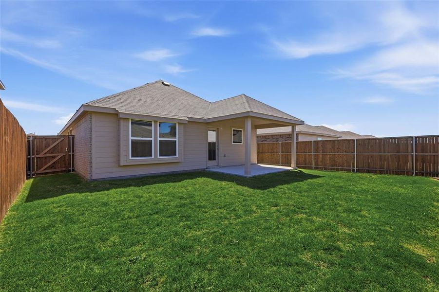 Back of house with a gate, a patio, a fenced backyard, brick siding, and roof with shingles