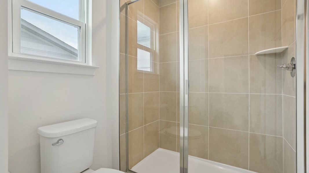 Glass Door Shower primary bath of the Coronado - End at Cyrene at Harmony located in St Cloud FL by DRB Homes