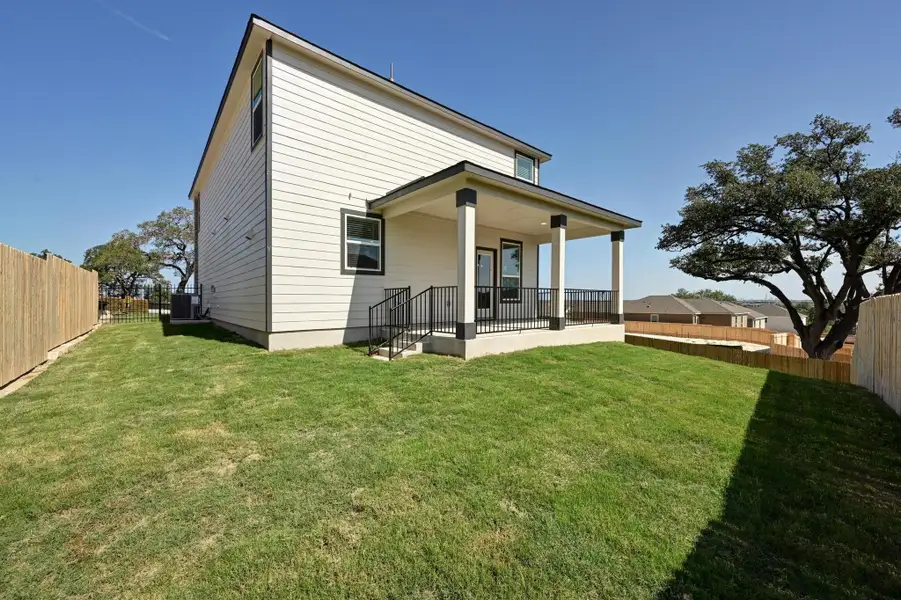 Front exterior of a new home in Creekside at Estancia, Austin, TX, highlighting curb appeal (Image 1). Front exterior of a new home in Creekside at Estancia, Austin, TX, highlighting curb appeal (Image 1).