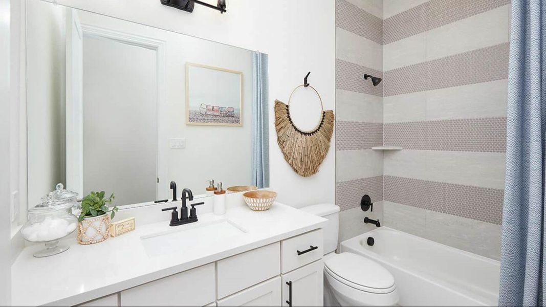 Bathroom featuring shower / tub combo and vanity Bathroom featuring shower / tub combo and vanity