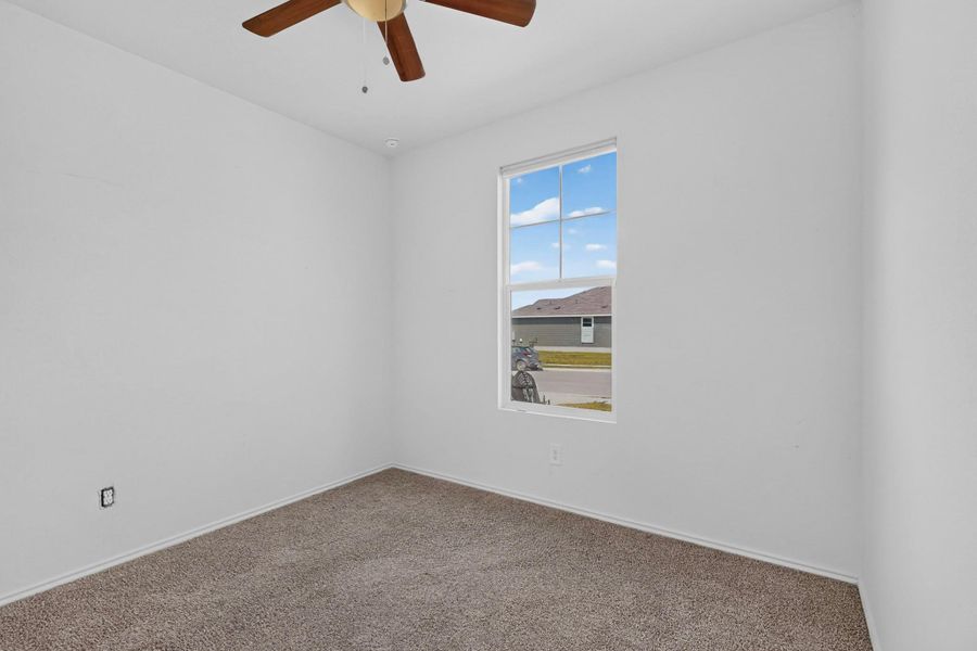 Plush carpeting and a classic multi-lite window define this versatile secondary room. Plush carpeting and a classic multi-lite window define this versatile secondary room.