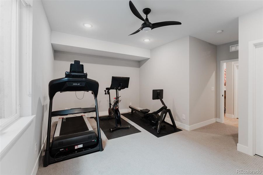 The well-appointed bedroom provides guests with a stay that rivals five-star luxury. Alternatively, it can be purposed as a fully equipped home fitness center.