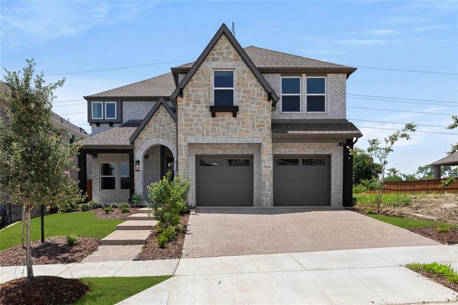 Front exterior of a new home in Inspiration, Seis Lagos, TX, highlighting curb appeal (Image 1).