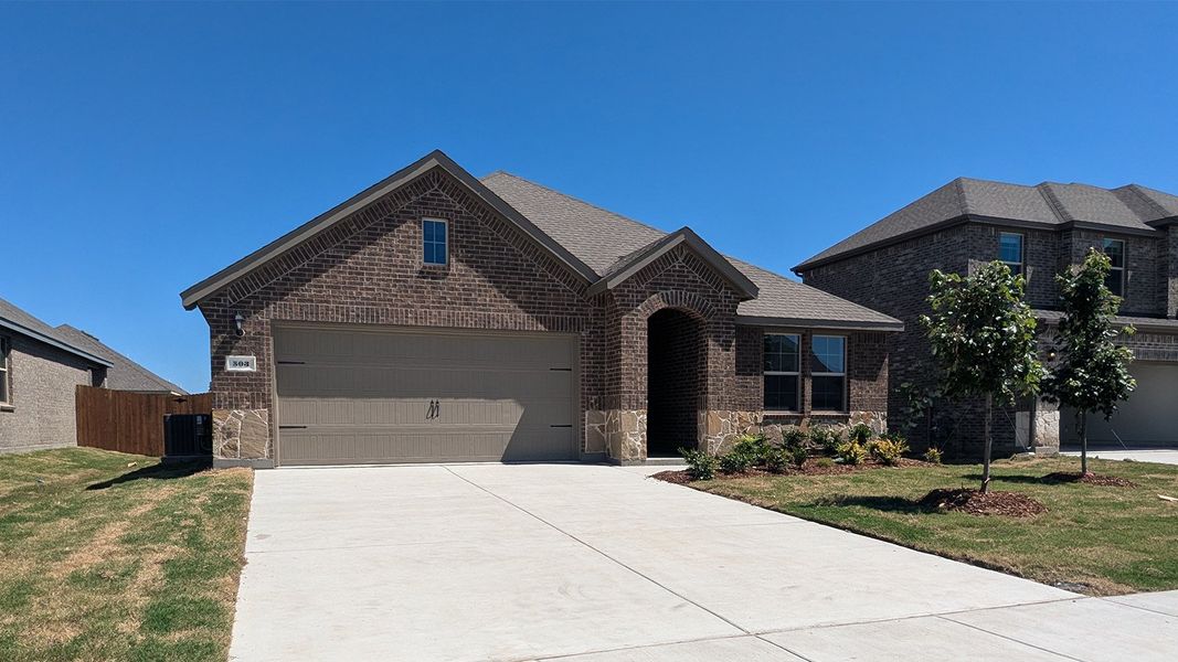 Front exterior of a new home in Trailstone, Caddo Mills, TX, highlighting curb appeal (Image 1). Front exterior of a new home in Trailstone, Caddo Mills, TX, highlighting curb appeal (Image 1).