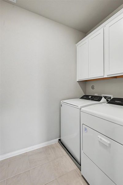 The utility room offers convenient laundry space with built-in cabinetry for added storage. The utility room offers convenient laundry space with built-in cabinetry for added storage.