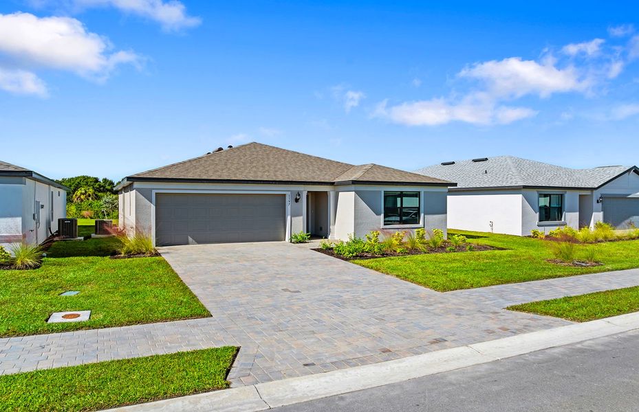 Front exterior of a new home in Caloosa Cove, Labelle, FL, highlighting curb appeal (Image 18).