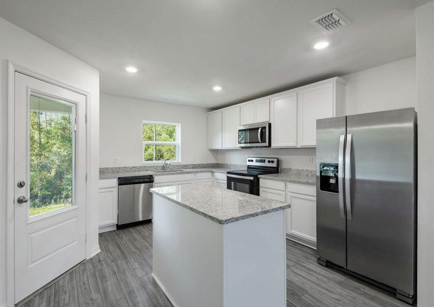 The kitchen is chef-ready with stainless steel appliances