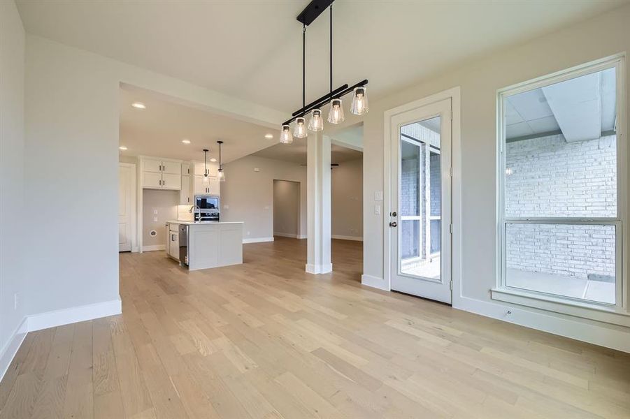 Unfurnished living room with light wood-type flooring and recessed lighting