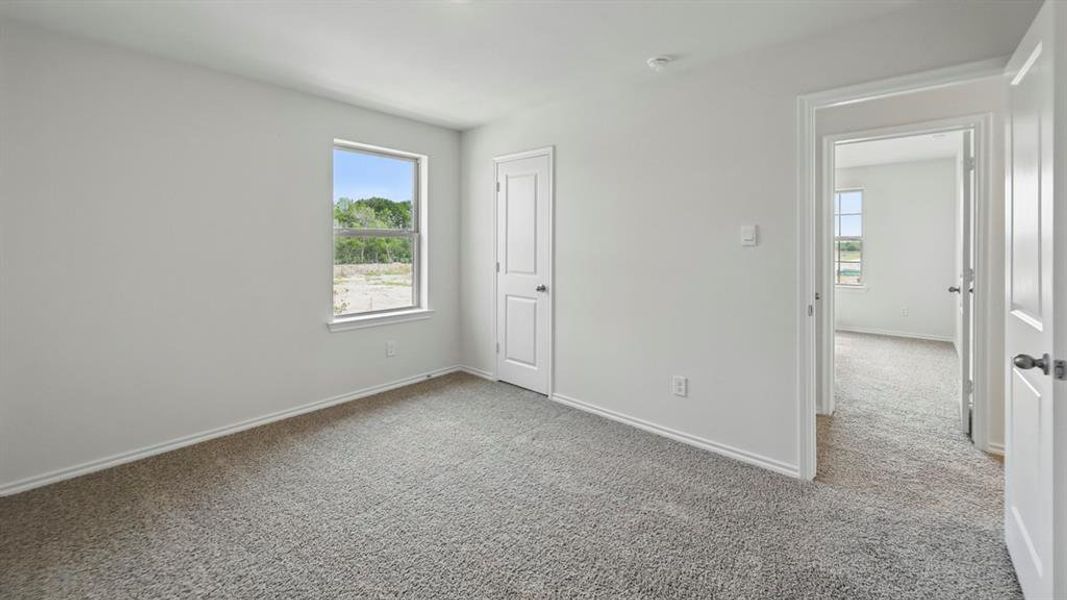 Unfurnished bedroom with light carpet and a closet