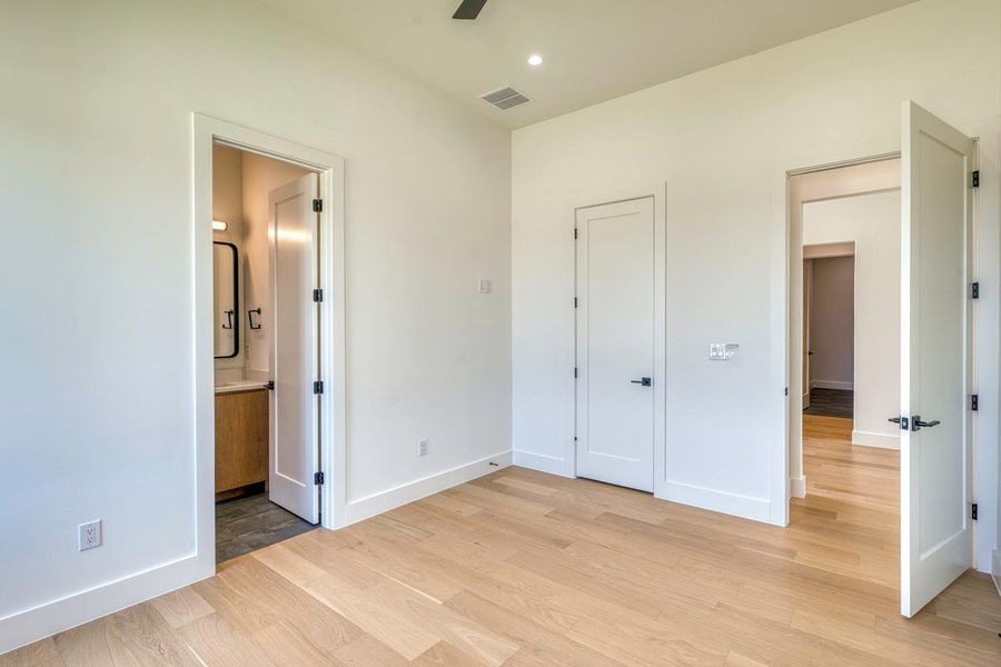 Smooth wood floors and tall doorways create an airy feel throughout the space.
