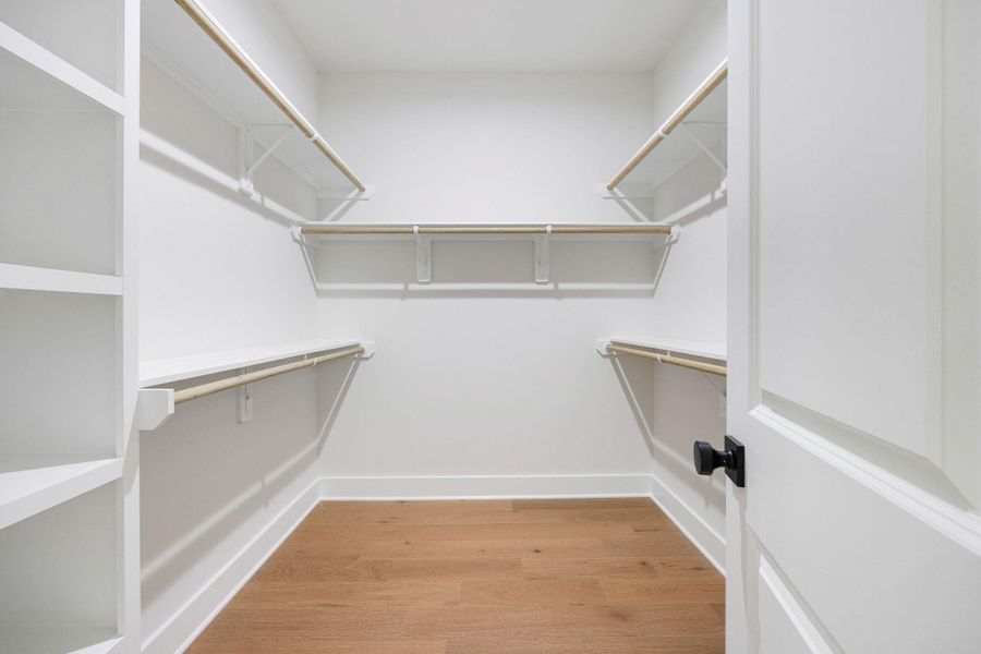 primary closetLarge walk-in closet with built-in shelving primary closetLarge walk-in closet with built-in shelving