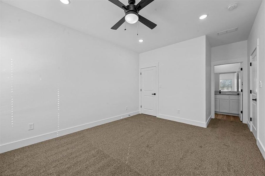 Unfurnished bedroom with carpet flooring and ceiling fan