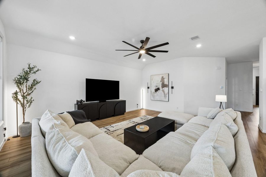 The living room is open and spacious. A oversized fan and automatic shades stand out in this elegant space. The living room is open and spacious. A oversized fan and automatic shades stand out in this elegant space.