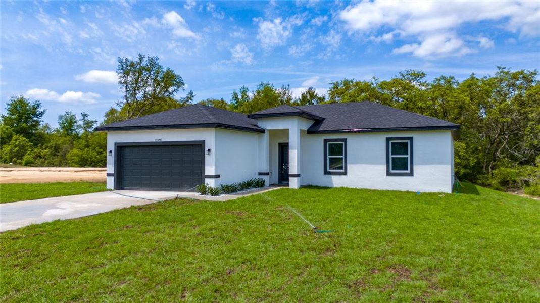 Front exterior of a new home in , Ocala, FL, highlighting curb appeal (Image 13).