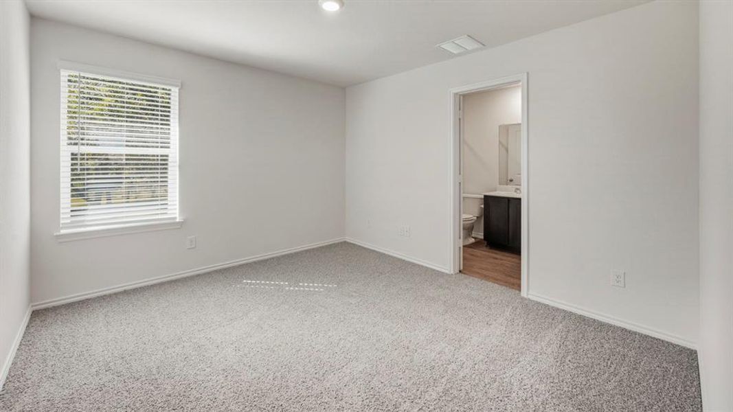 Unfurnished bedroom featuring light carpet, connected bathroom, and recessed lighting