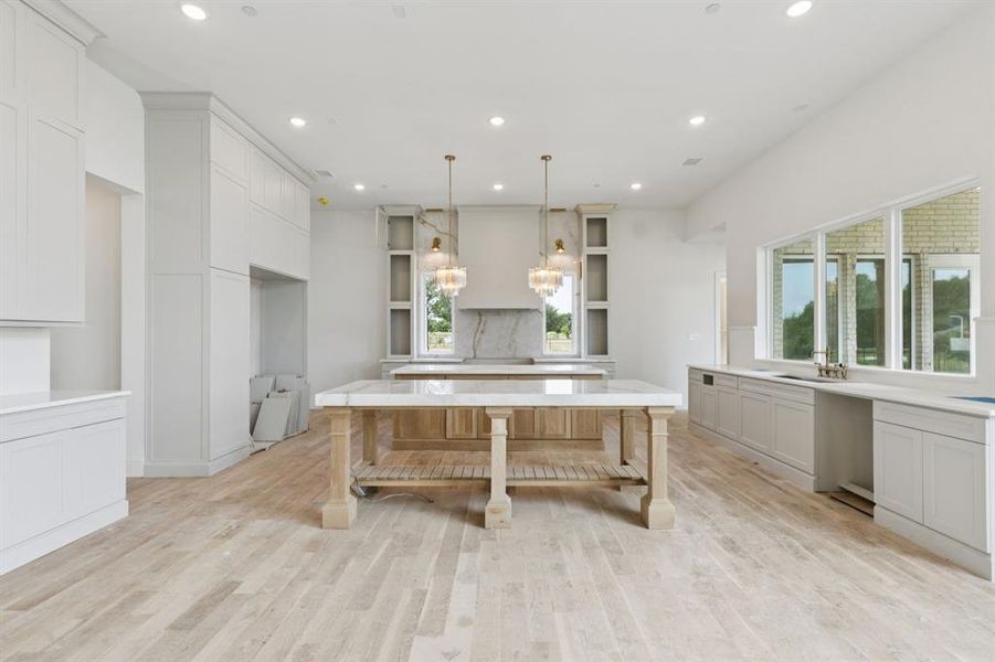 The gourmet kitchen is a true masterpiece with two oversized islands, Cristallo quartz counters, commercial grade Bertazzoni appliances, 48in dual-fuel range with 6 burners plus griddle, double oven and convection, 60in built-in refrigerator and freezer, and range hood with state-of-the-art ventilation system.