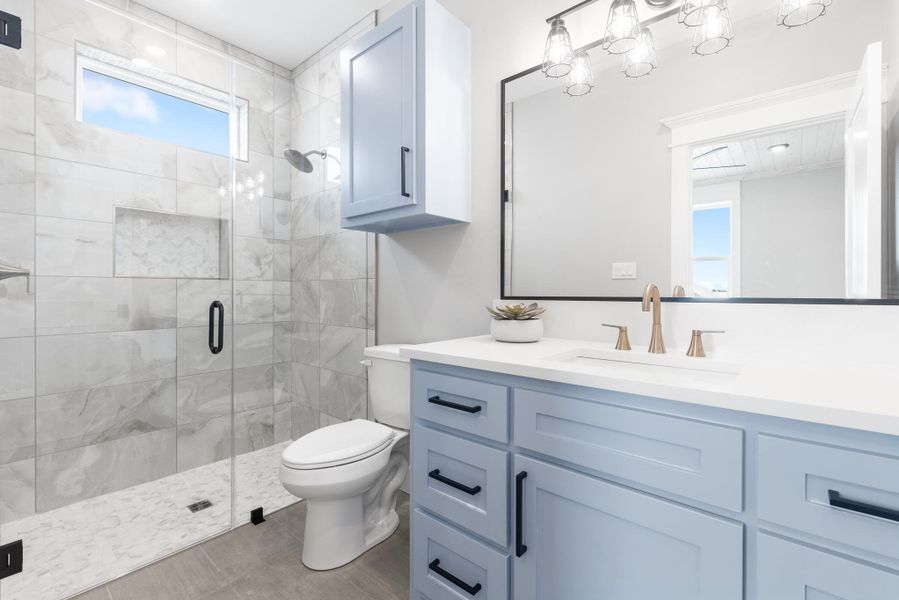 Full bathroom with vanity and a stall shower Full bathroom with vanity and a stall shower