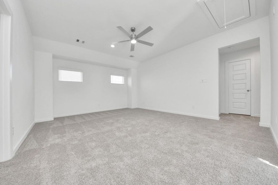 Ascend to relaxation in this fantastic game room! Ideal for both casual gatherings and adult gaming, it boasts plush carpet, lofty ceilings, custom paint, and ample windows for abundant natural light. Sample photo of completed home with similar floor plan. Actual colors and selections may vary.