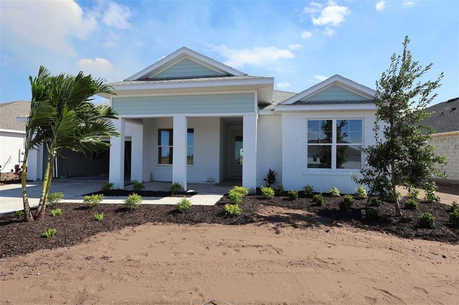Front exterior of a new home in Coasterra, Palmetto, FL, highlighting curb appeal (Image 1).