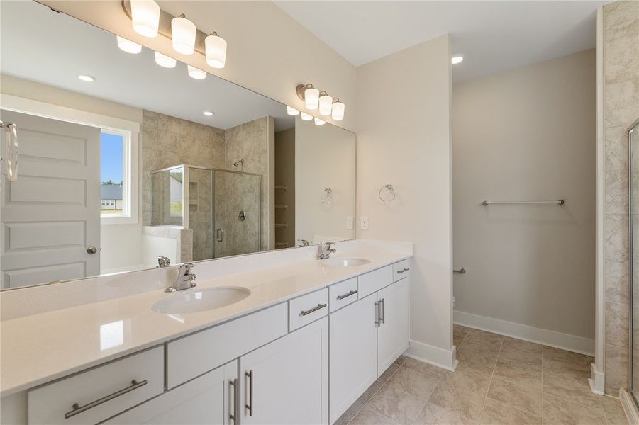 Dual vanities with pristine countertops and a spac