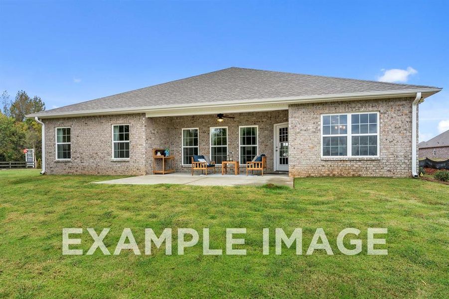 Back of house featuring a patio area, ceiling fan, and a yard